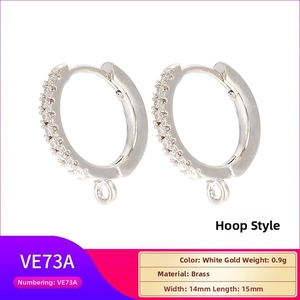 Detail showing white gold plated brass earrings with cubic zirconia and hanging loop