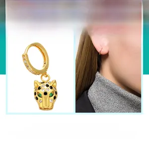 Detail of leopard head earring charm with micro-paved zircons and green stone eyes