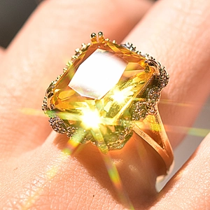 Luxurious gold plated ring with large champagne square cut gemstone and side stones