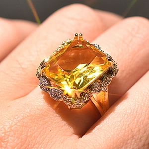 Gold-plated ring with large emerald-cut champagne gemstone and sparkling accents