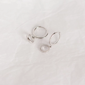 Macro detail of S925 sterling silver hoop earrings with sparkly cubic zirconia charms