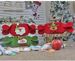 Close-up of festive felt Christmas candy bags with cartoon Santa and reindeer decorations