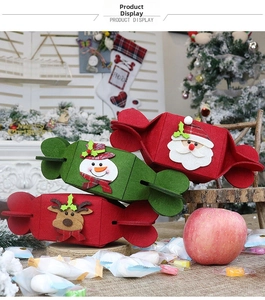 Detailed view of red and green felt candy-shaped gift bags with Santa and snowman appliques
