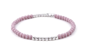 Detail of pink crystal faceted beads and silver metal square spacers on a beaded bracelet