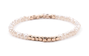 Detail of Miyuki stretch bracelet with beige faceted beads and rose gold metal tubes