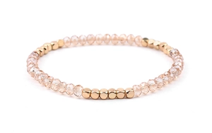 Detail of Miyuki stretch bracelet with champagne faceted beads and gold metal spacers