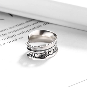 Macro detail of vintage bird and vine engraving on s925 silver open adjustable ring