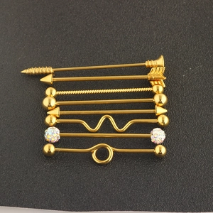 Detailed set of rose gold industrial barbells with arrow and rhinestone screw ends