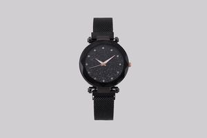 Close-up of starry sky watch dial with diamond markers and black Milanese mesh strap