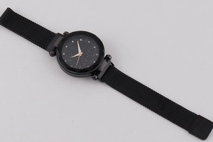 Detailed macro shot of a starry sky dial quartz watch with black Milanese magnetic band
