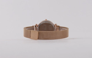 Detailed back view of rose gold quartz watch with Milanese band and stainless steel case