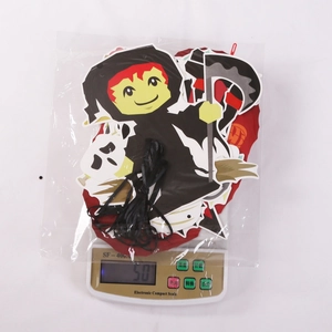 Detailed view of Halloween paper ghost and reaper banner set weighed at 50g on a scale