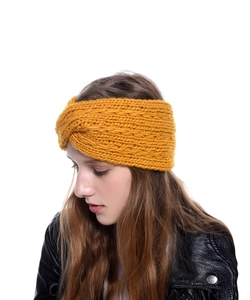 Close-up of ginger yellow chunky knit headband with criss-cross knot detail