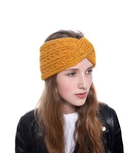 Detailed knit texture of a mustard yellow chunky twist headband for winter hair styling