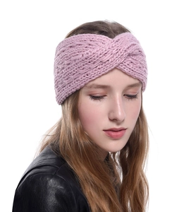 Detail view of pink thick knit headband showing warm texture and crossover knot design