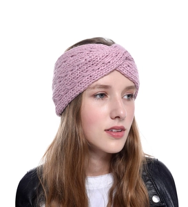 Detail shot of a pink chunky knit winter headband with a classic crossover knot design