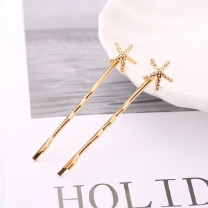 Set of two gold starfish hair clips for women with a stylish ocean-inspired metal design