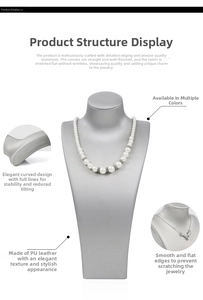 Detail view of grey PU leather jewelry bust stand with necklace and fine stitching