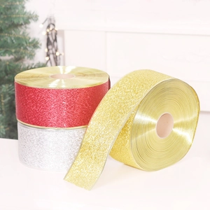 Golden, silver, and red glitter ribbon rolls for Christmas tree and festive decorations