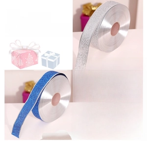 Close-up of glittery silver and blue ribbons with metallic fiber for Christmas gift wrapping