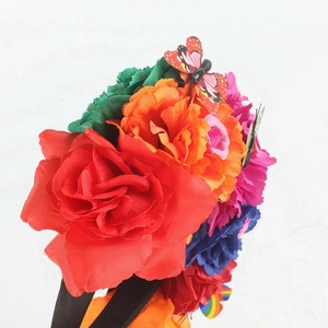 Detail of colorful fabric roses and butterfly on the Mexican floral party headband