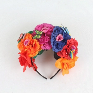 Detail of vibrant faux peonies and butterflies on a Mexican style party headband