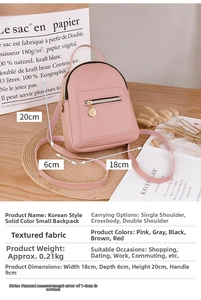 Pink mini backpack for women in vegan leather with adjustable straps shown on a table