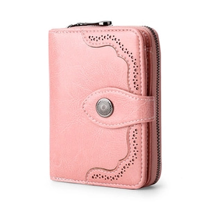 Detail of pink leather wallet featuring wavy cutout patterns and secure snap button closure