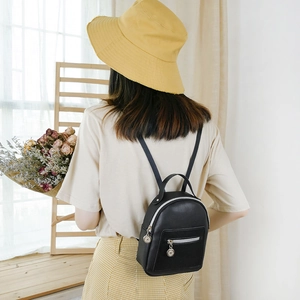 Mini black leather backpack for women with silver zipper in a casual aesthetic lifestyle shot