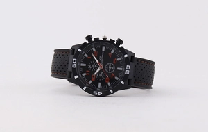 Close-up of GT Grand Touring sports watch with black silicone strap and red stitching details