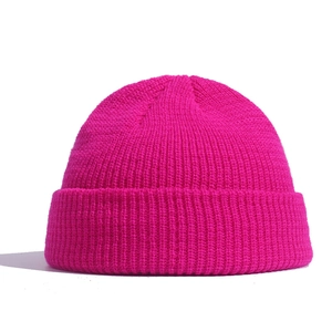 Vibrant rose pink knit docker cap with ribbed texture and turn-up brim for winter