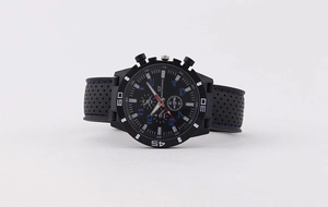 Macro detail of chronograph dial with blue numerals and perforated silicone strap