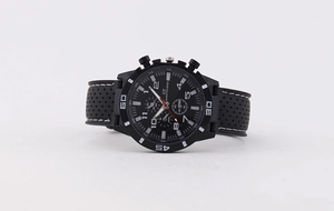 Detailed macro view of black sport chronograph watch dial with GT logo and white stitching