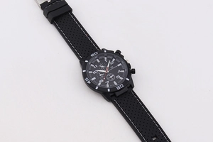 Close-up of black sports watch with silicone breathable strap and three sub-dials