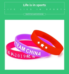Detailed view of colorful Team China silicone wristbands with custom printed text and logos