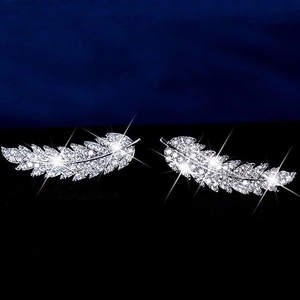 Close-up of silver feather earrings with micro-set white cubic zirconia crystals