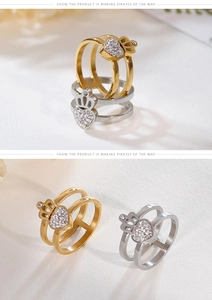 Close-up of dual-layer crown heart ring with sparkling white rhinestones and gold plating