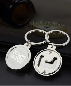 Detail view of a metal bottle cap opener keychain with Snow Beer logo and screw fixings