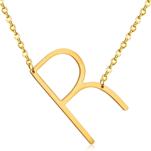 Macro shot of 18K gold plated stainless steel letter R pendant on a thin metal chain