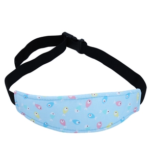 Detail of adjustable baby car seat head support strap with cute fish pattern and buckle