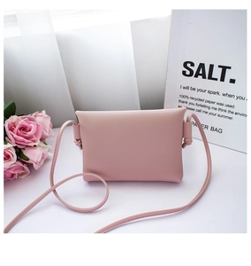 Detailed view of a pink minimalist mini PU leather bag with side-knotted straps and flowers