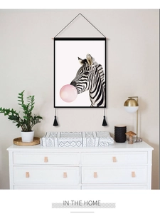 Detail of zebra blowing pink bubble scroll painting with black tassels and hanging rod