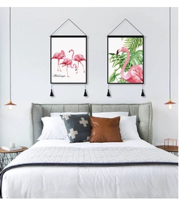 Detail of Nordic flamingo wall tapestries with elegant black tassels in a bedroom setting