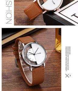 Detailed view of TOMI watch featuring a brown leather strap and hollow skeleton dial design