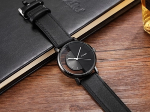 Close-up of TOMI watch with hollow semi-transparent dial and black leather strap