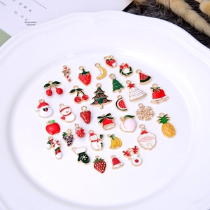 Collection of colorful enamel DIY charms with holiday and fruit themes for jewelry making