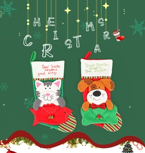 Detail of Christmas stockings with cat and dog embroidery on festive green background
