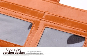 Detail of brown leather wallet featuring dual transparent ID windows and neat stitching