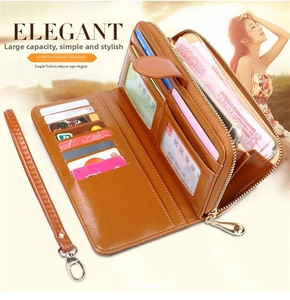 Detailed interior of brown leather zip wallet with multiple card slots and wrist strap