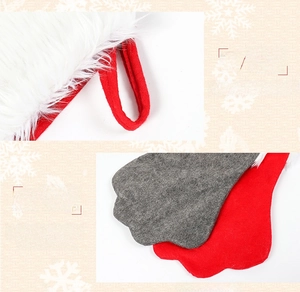 Detail view of red dog paw Christmas stocking with plush cuff and hanging loop